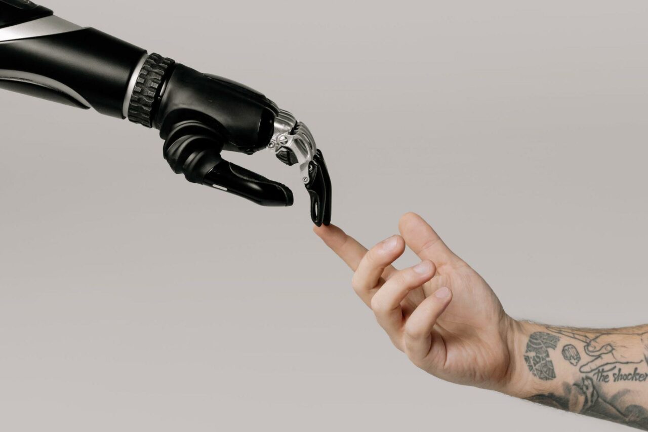 Hand of a robot touching the hand of a human 